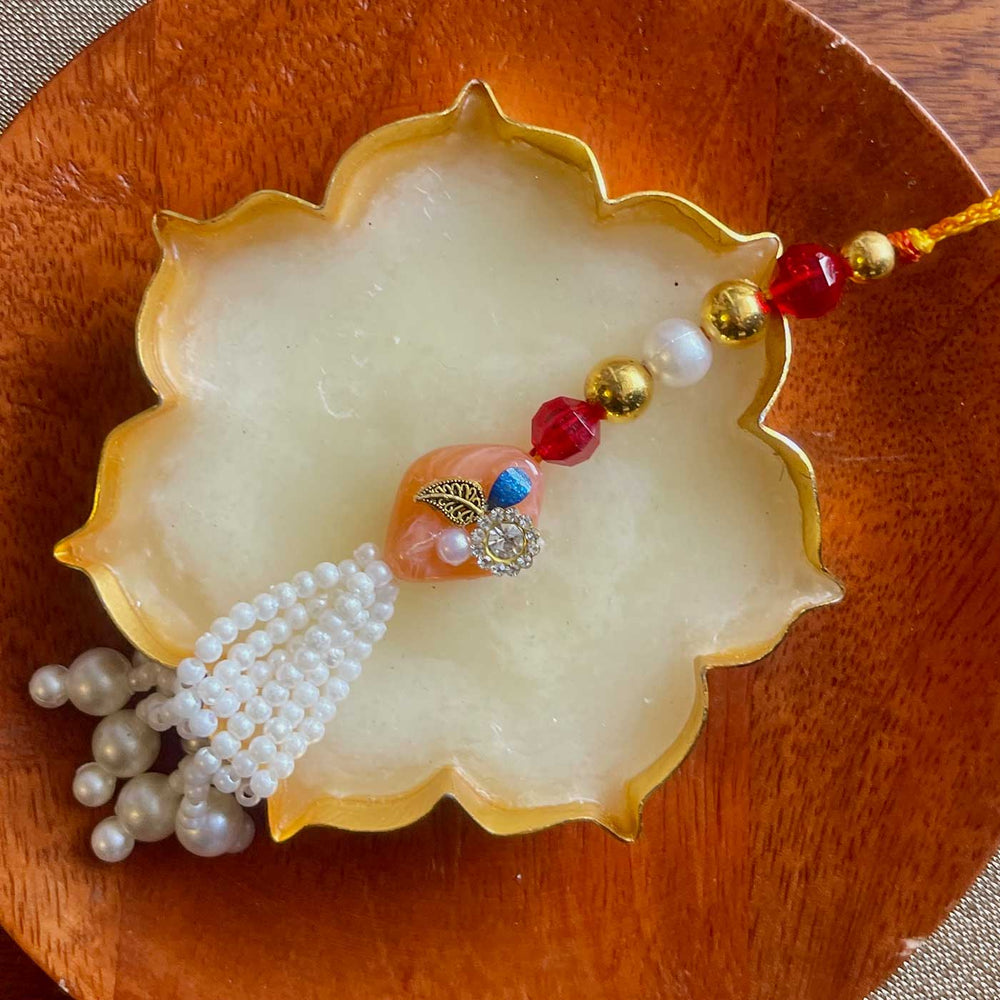 Handmade Green And Pink Design Pearl And Stone Bhaiya Bhabhi Rakhi - Close-up of Orange Bead Detail