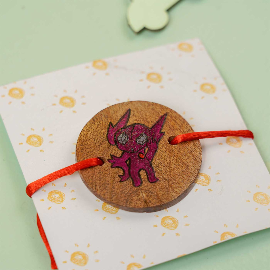 Personalized Hand Painted Sableye Wooden Rakhi With Roli Chawal - Angled Front View on Gift Card
