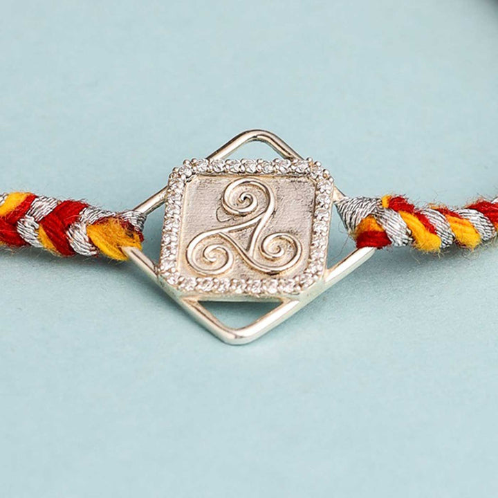 Handmade Three Swirl Design Silver Rakhi For Brother - Detailed close-up of bracelet charm