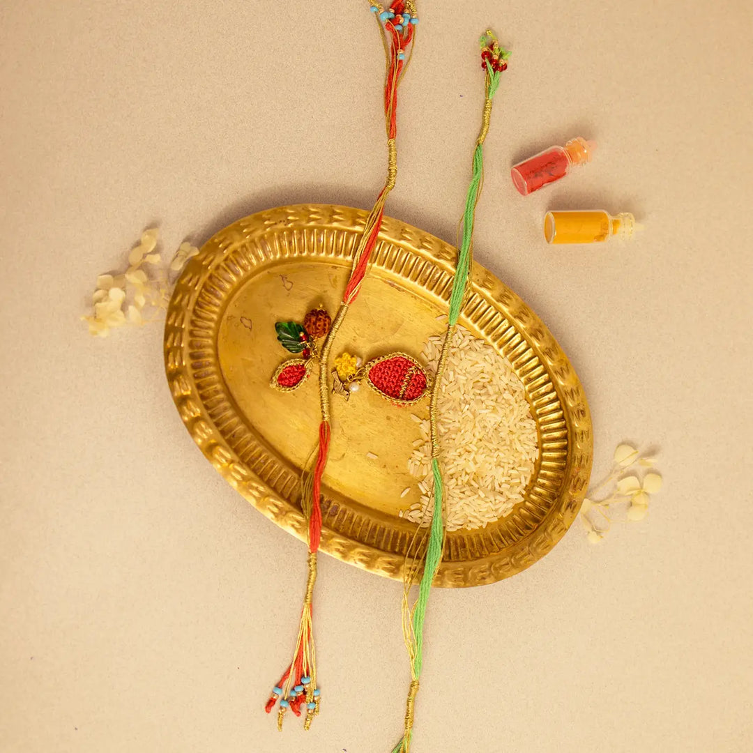 Handmade Crochet Ananya Paati Rakhi With Roli Chawal Set Of 2 - Full View with Decorative Items