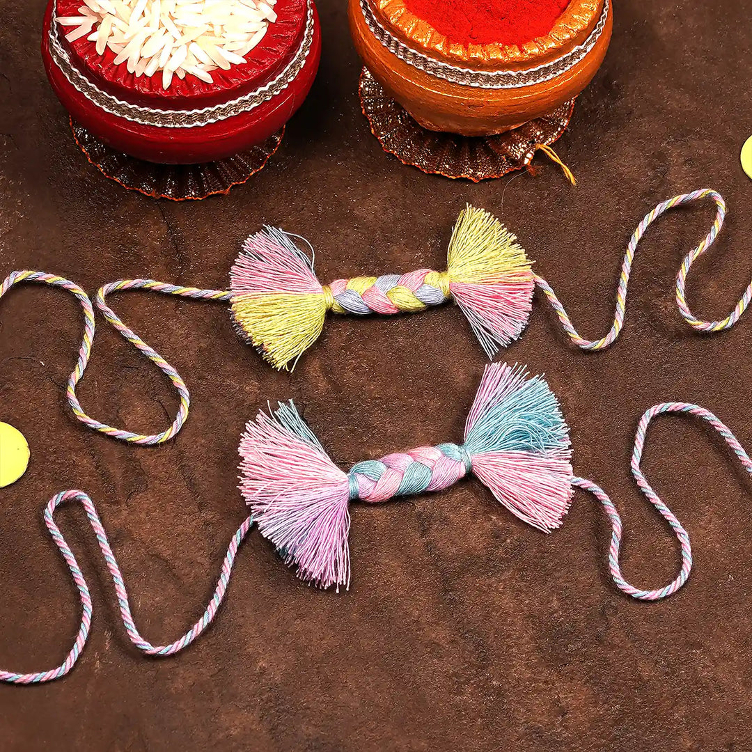 Handmade Braided Candy Rakhi With Roli Chawal Set Of 2 - Flat Lay with Decorative Containers