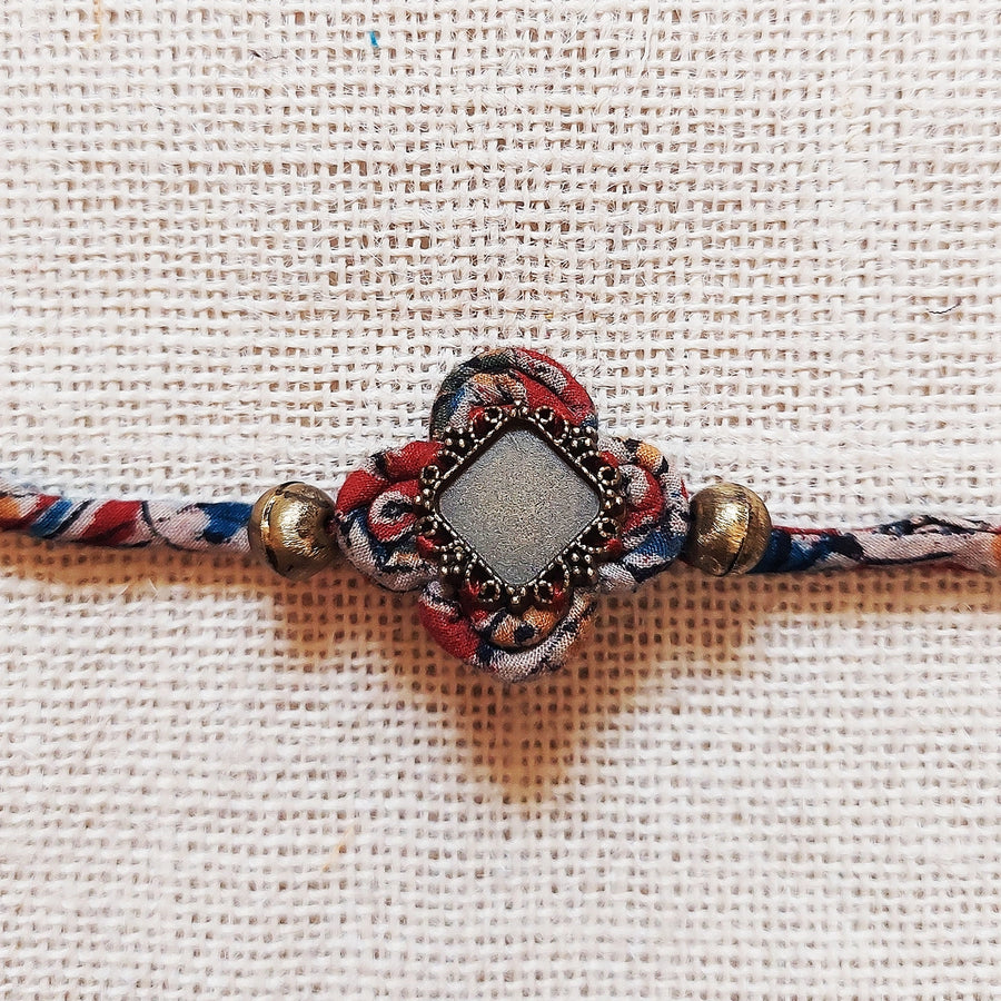 Handmade Dori Work Beaded Ethnic Rakhi With Roli Chawal - Close-up of central decorative detail