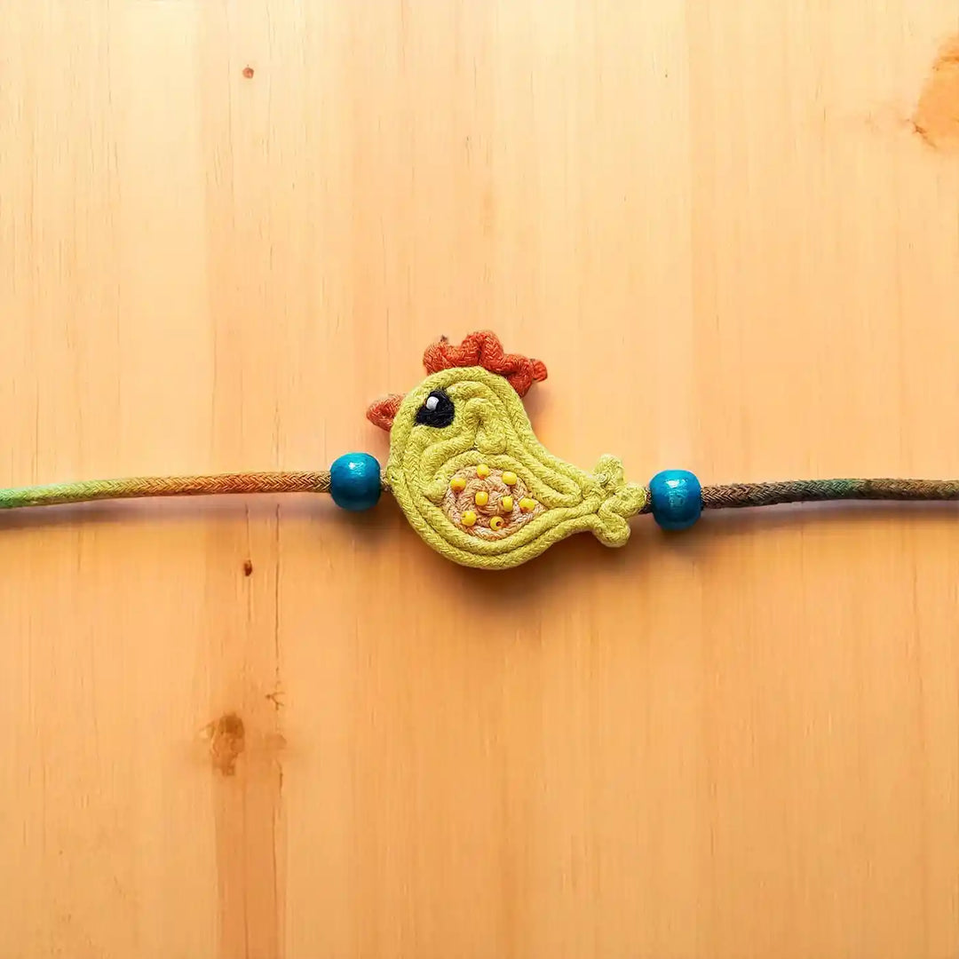 Handmade Dori Work Cute Chick Kids Rakhi With Roli Chawal - Close-up of Bird Charm