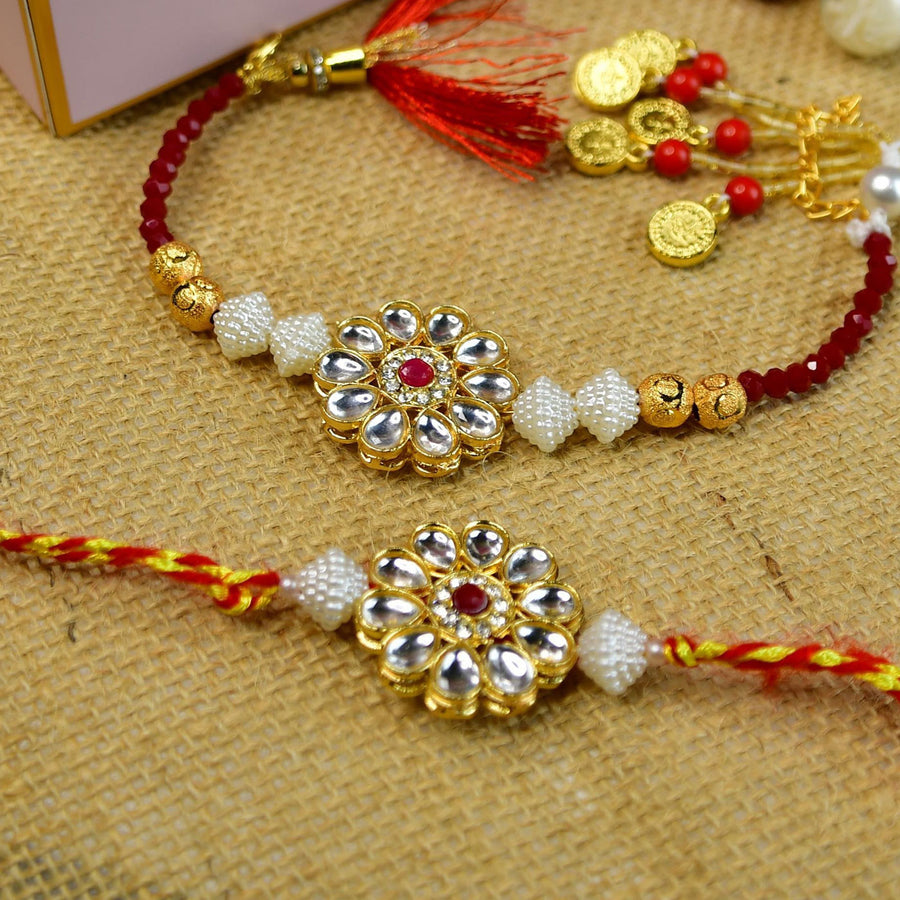 Beaded Floral Pearl And Stone Rakhi Hamper With Chocolates And Roli Chawal For Bhaiya And Bhabhi Customizable Options Includes Up To 7 Goodies - Close-up of two rakhis