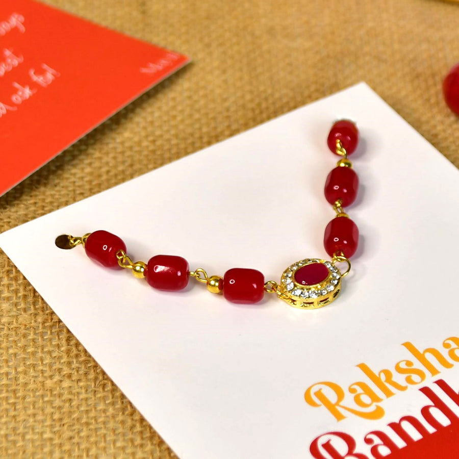 Beaded Red Pearl And Stone Bracelet Rakhi Hamper With Chocolates And Roli Chawal For Brother Customizable Options Includes Up To 7 Goodies - Close-up of Rakhi bracelet