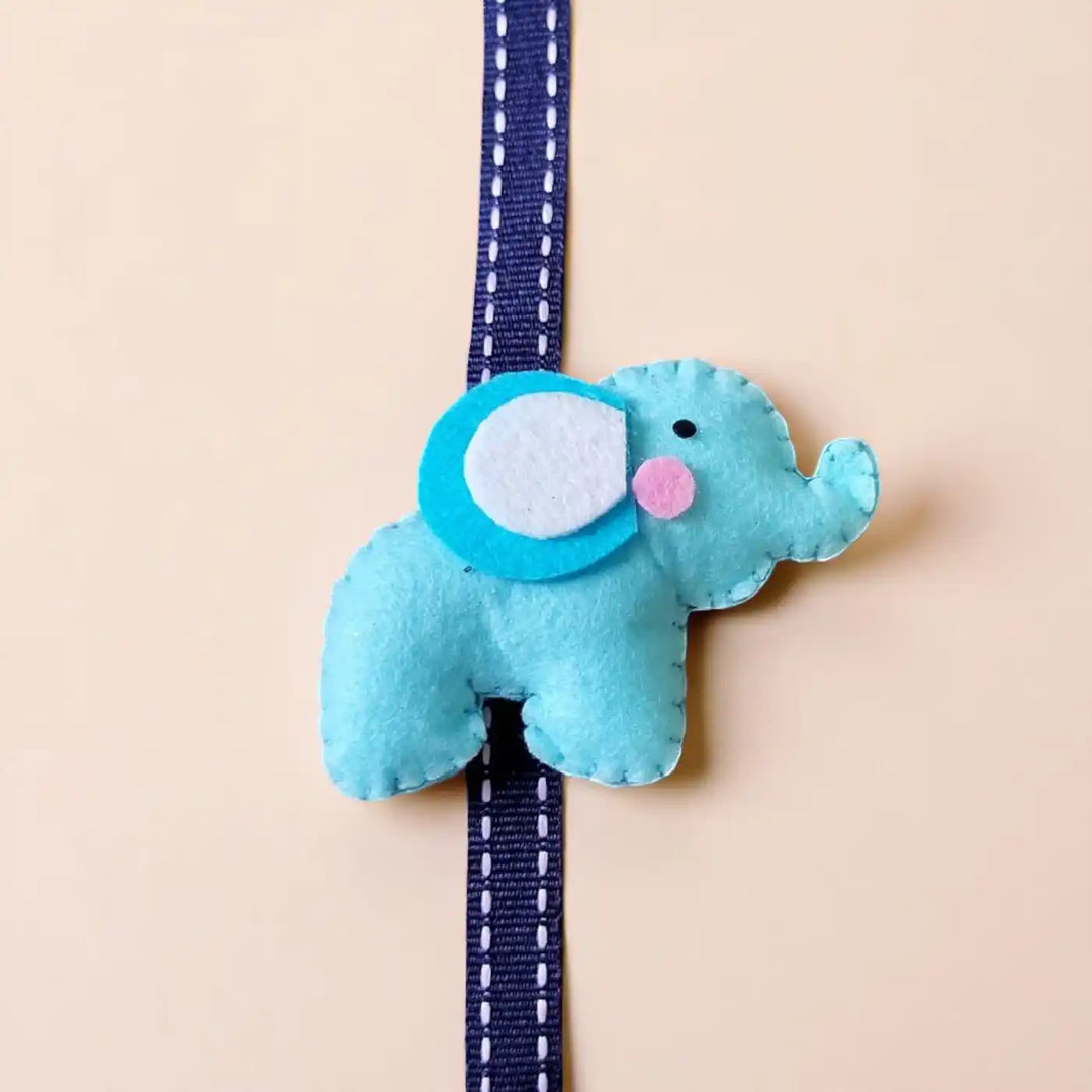 Handmade Elephant Theme Felt Kids Rakhi With Roli Chawal - Close-up on Blue Elephant Ornament
