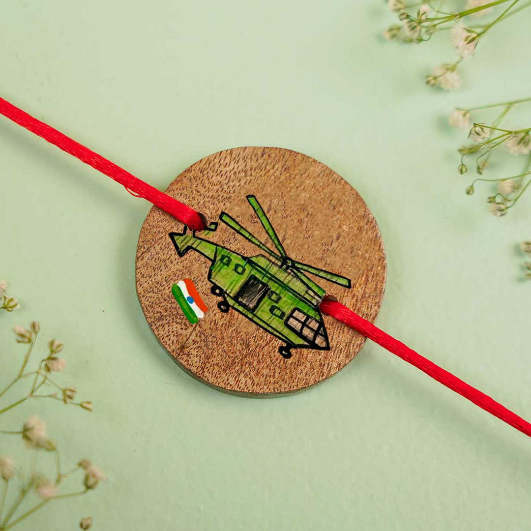 Personalized Hand Painted Helicopter Wooden Rakhi With Roli Chawal - Flat Lay Close-up View