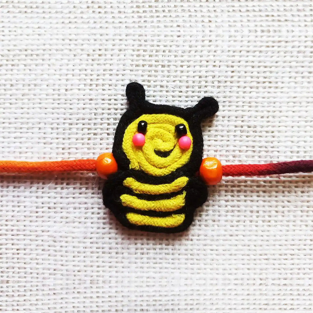 Handmade Dori Work Cute Bumble Bee Kids Rakhi With Roli Chawal - Close-up Front View