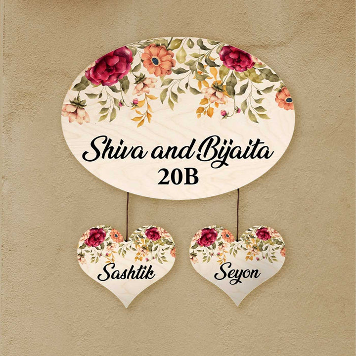 Printed Red And Orange Floral Wooden Oval Nameplate For Family - Mounted Showing Hanging Hearts