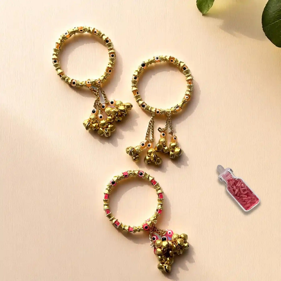 Handmade Golden Evil Eye And Ghungroo Bangle Lumba Rakhi For Bhabhi With Roli Chawal - Flat Lay with Accessories