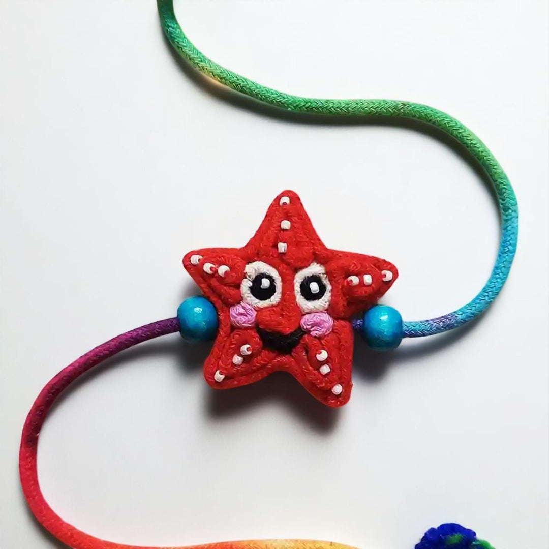 Handmade Dori Work Starfish Kids Rakhi With Roli Chawal - Close-up of Star Charm