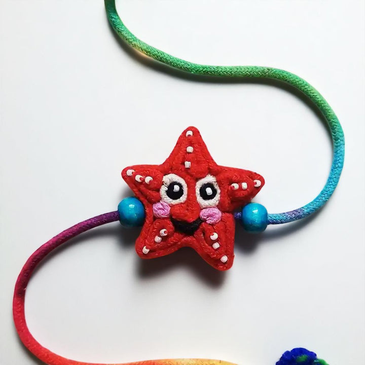 Handmade Dori Work Starfish Kids Rakhi With Roli Chawal - Close-up of Star Charm