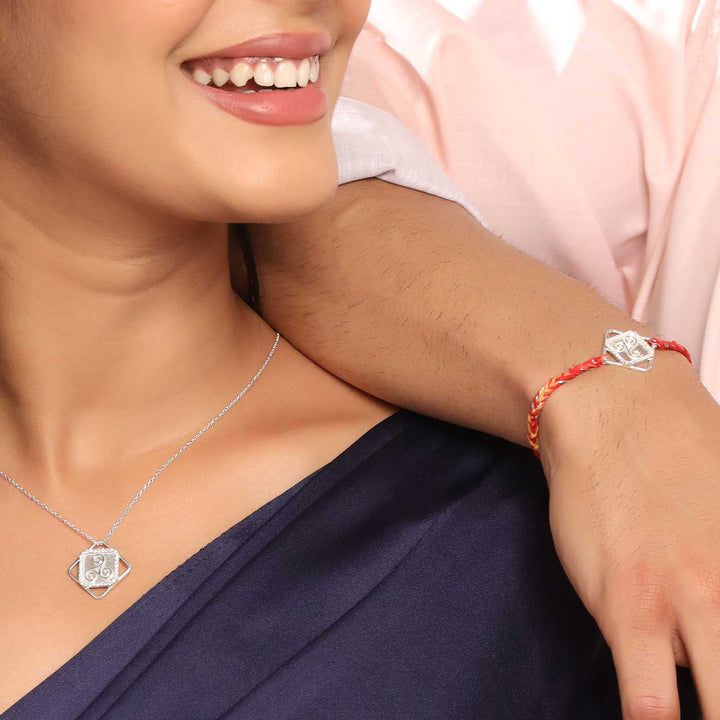 Handmade Three Swirl Design Silver Rakhi For Brother - Model wearing necklace and bracelet