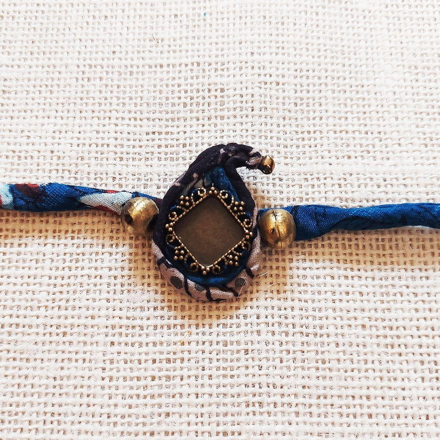 Handmade Dori Work Ambi Ajrakh Rakhi With Roli Chawal - Close-up of Decorative Centerpiece