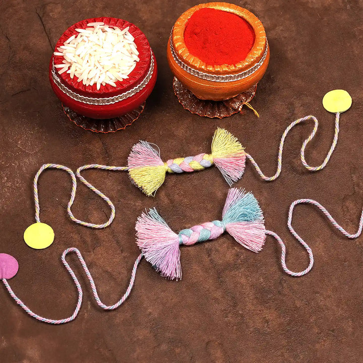 Handmade Braided Candy Rakhi With Roli Chawal Set Of 2 - Flat Lay with Decorative Containers and Dots