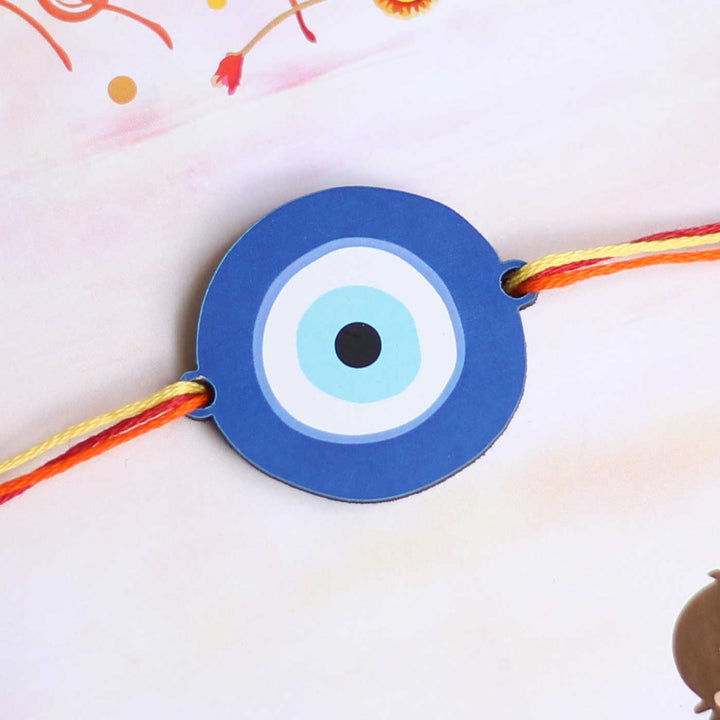 Handmade Evil Eye Design Magnet Wooden Rakhi With Roli Chawal - Close-up View of Evil Eye Charm