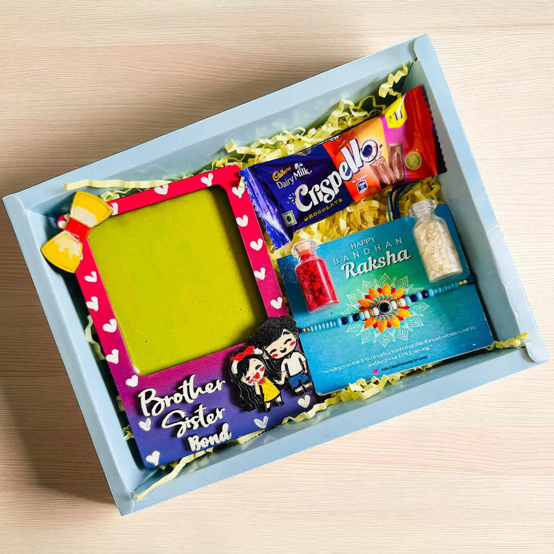 Photo Personalized Brother Sister Bond Mdf Wood Rakhi Hamper With Chocolates And Roli Chawal Includes 1 Fridge Magnet 1 Rakhi - Angled View Showing Contents