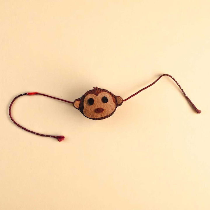 Handmade Beaded Monkey Theme Pom Pom Felt Rakhi With Roli Chawal For Kids - Front View with Strings Extended