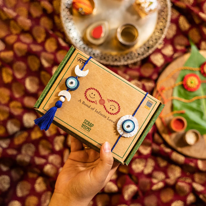 Nazarbattu Plantable Handmade Cork Sibling Rakhi Hamper With Roli Chawal - Hand Holding Gift Box