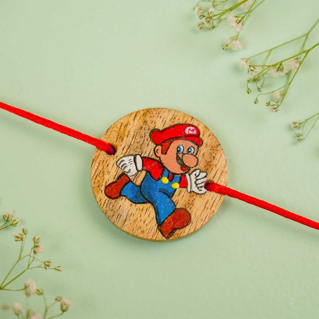 Personalized Hand Painted Mario Wooden Rakhi With Roli Chawal - Close-up with Floral Background