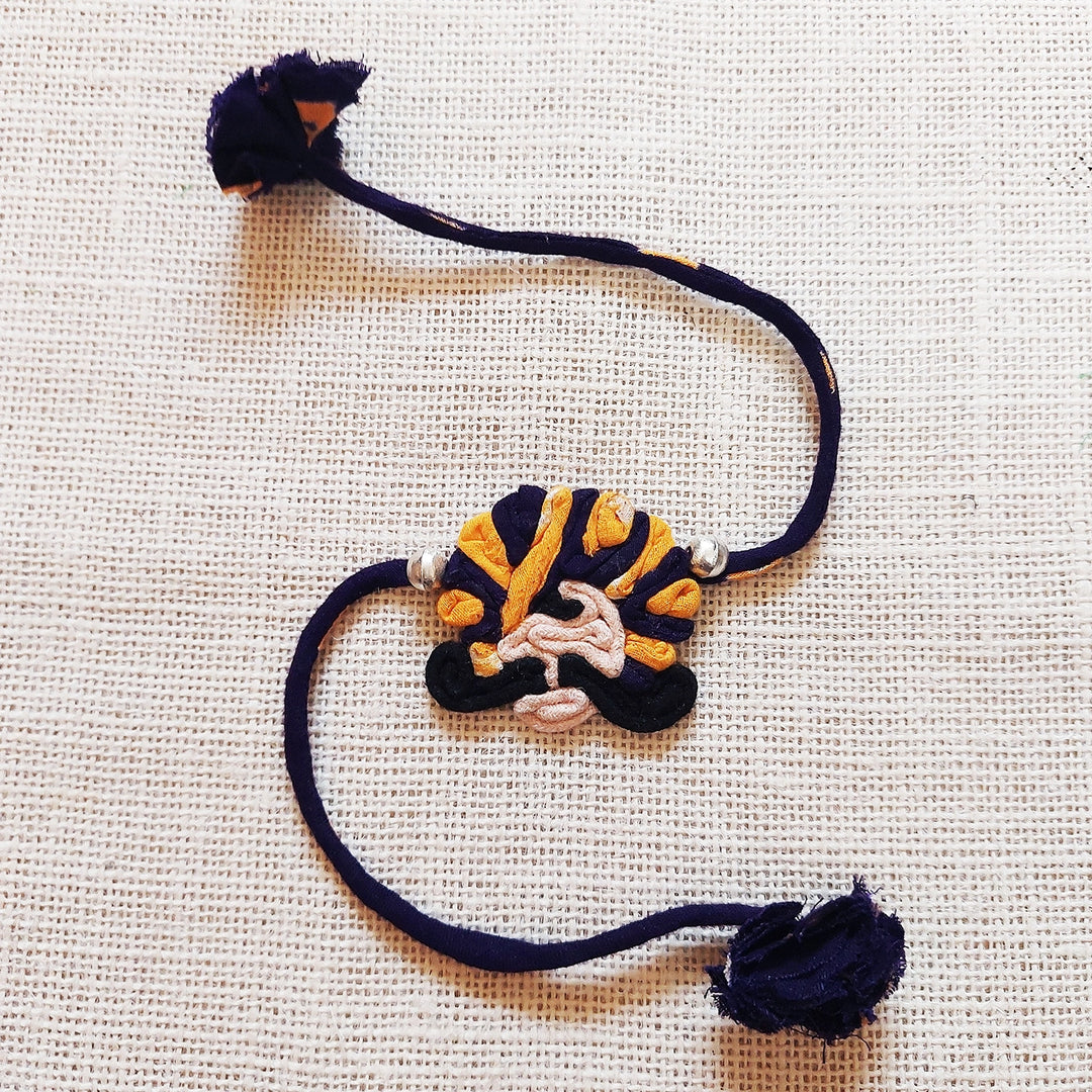 Handmade Dori Work Ethnic Rabari Rakhi With Roli Chawal - Flat Lay Purple Thread Bracelet