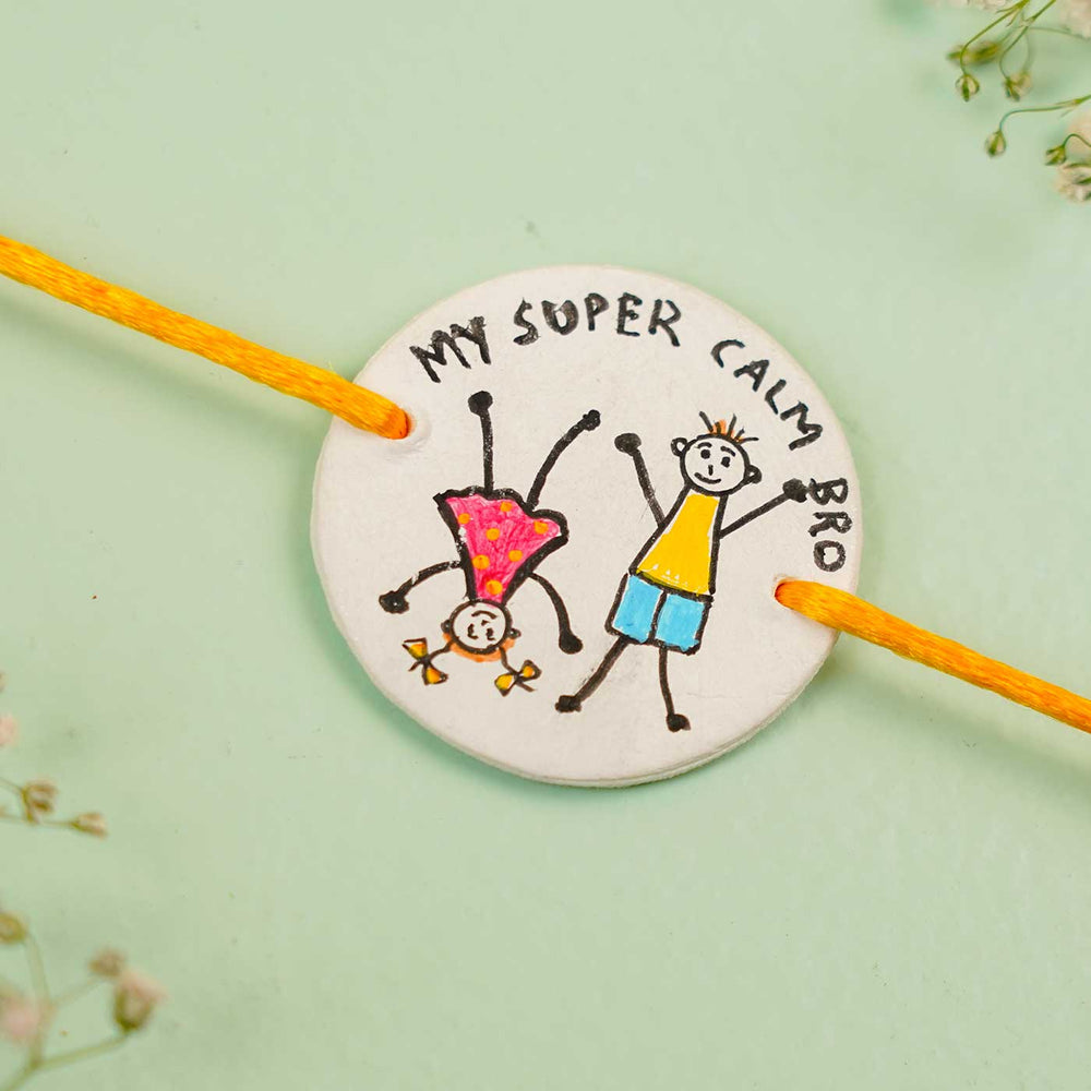 Personalized Hand Painted Super Calm Bro Clay Rakhi With Roli Chawal - Close-up View of Pendant