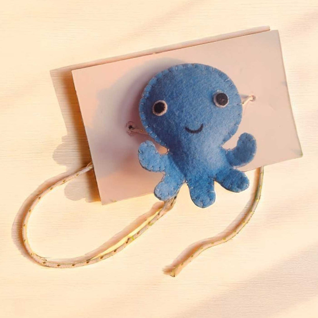 Customized Handmade Beaded Octopus Theme Felt Rakhi With Roli Chawal For Kids - Front View on Cardboard Backing
