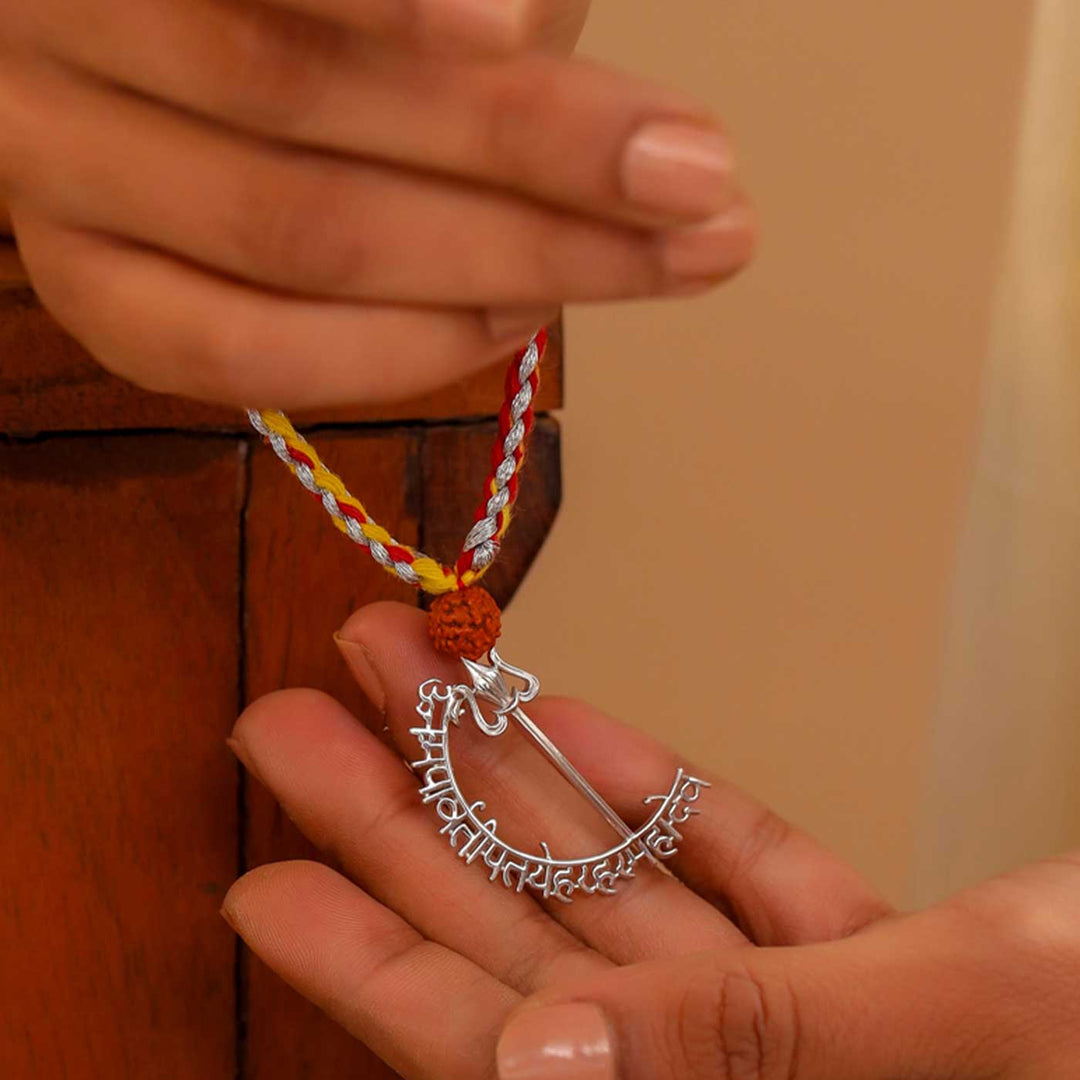 Handmade Mahadev Mantra Silver Lumba Rakhi For Bhabhi - Held in Hand Display