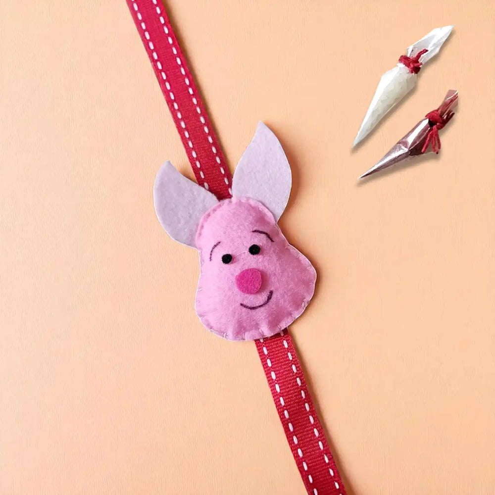 Handmade Piglet Theme Felt Kids Rakhi With Roli Chawal - Front View with Accessories