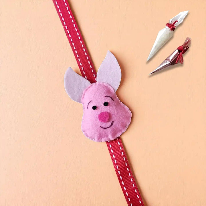 Handmade Piglet Theme Felt Kids Rakhi With Roli Chawal - Front View with Accessories