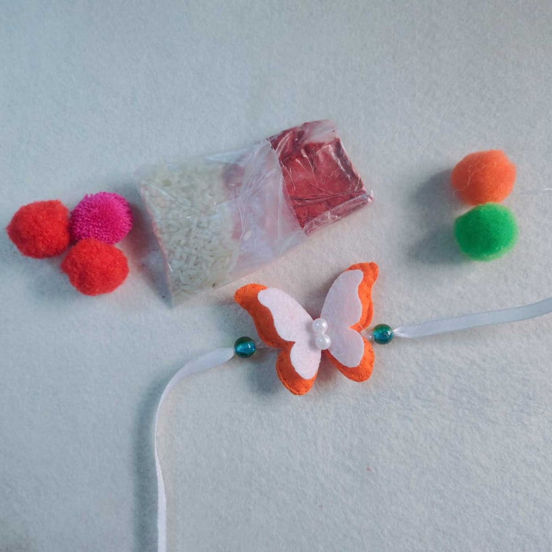 Customized Handmade Beaded Butterfly Theme Pom Pom Felt Rakhi With Roli Chawal For Kids - Product with Additional Craft Materials