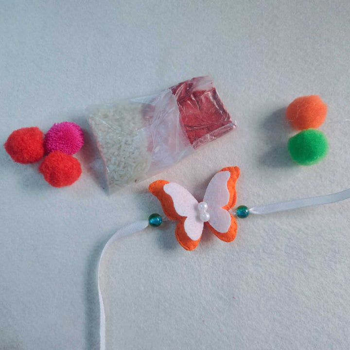 Customized Handmade Beaded Butterfly Theme Pom Pom Felt Rakhi With Roli Chawal For Kids - Product with Additional Craft Materials