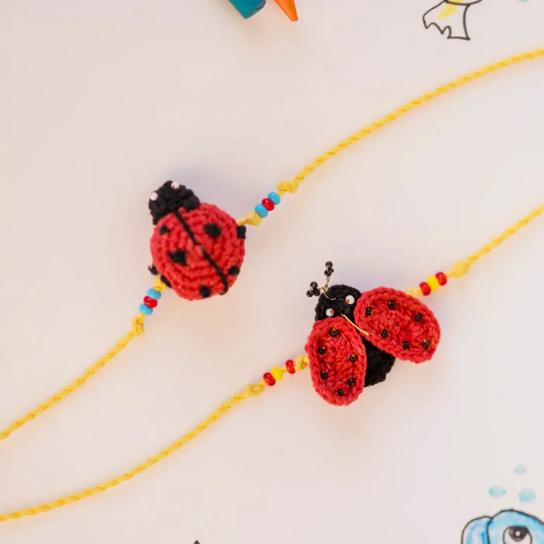 Handmade Crochet Mood Beetles Theme Kids Rakhi With Roli Chawal Set Of 2 - Close-up of Ladybug Charms