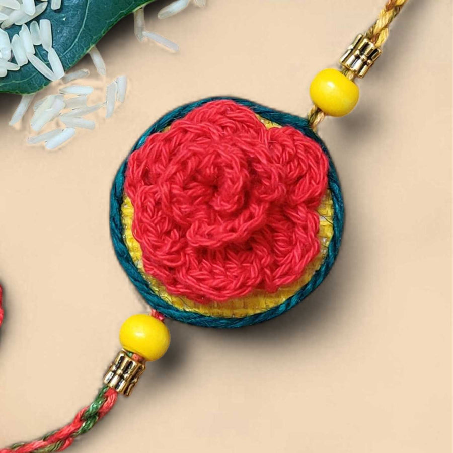Customized Handmade Crochet Rose Theme Cotton Rakhi With Roli Chawal - Close-up of Red Flower Detail