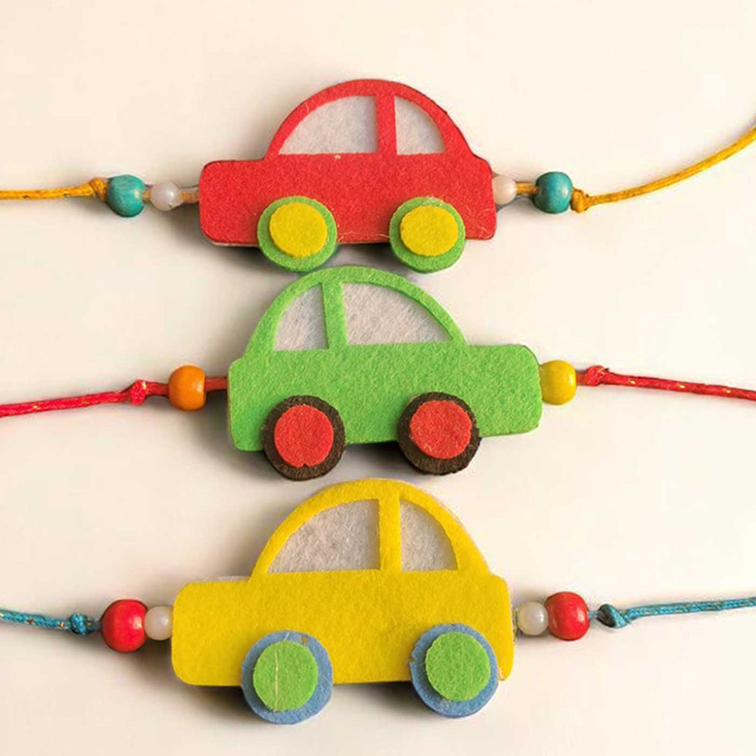 Customized Handmade Beaded Car Theme Pom Pom Felt Rakhi With Roli Chawal For Kids - Close-up of three car bracelets