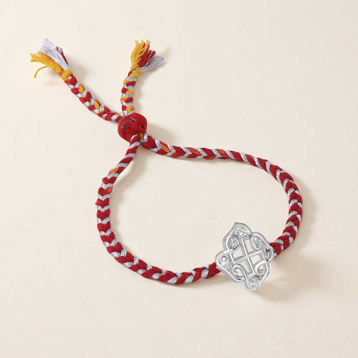 Handmade Swastik Design Silver Rakhi For Brother - Flat Lay on Neutral Background