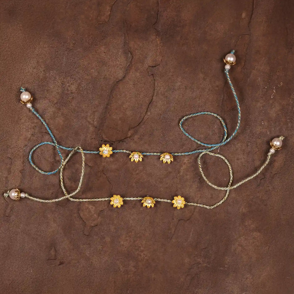 Handmade Golden Flower Rakhi With Roli Chawal Set Of 2 - Flat Lay Back View