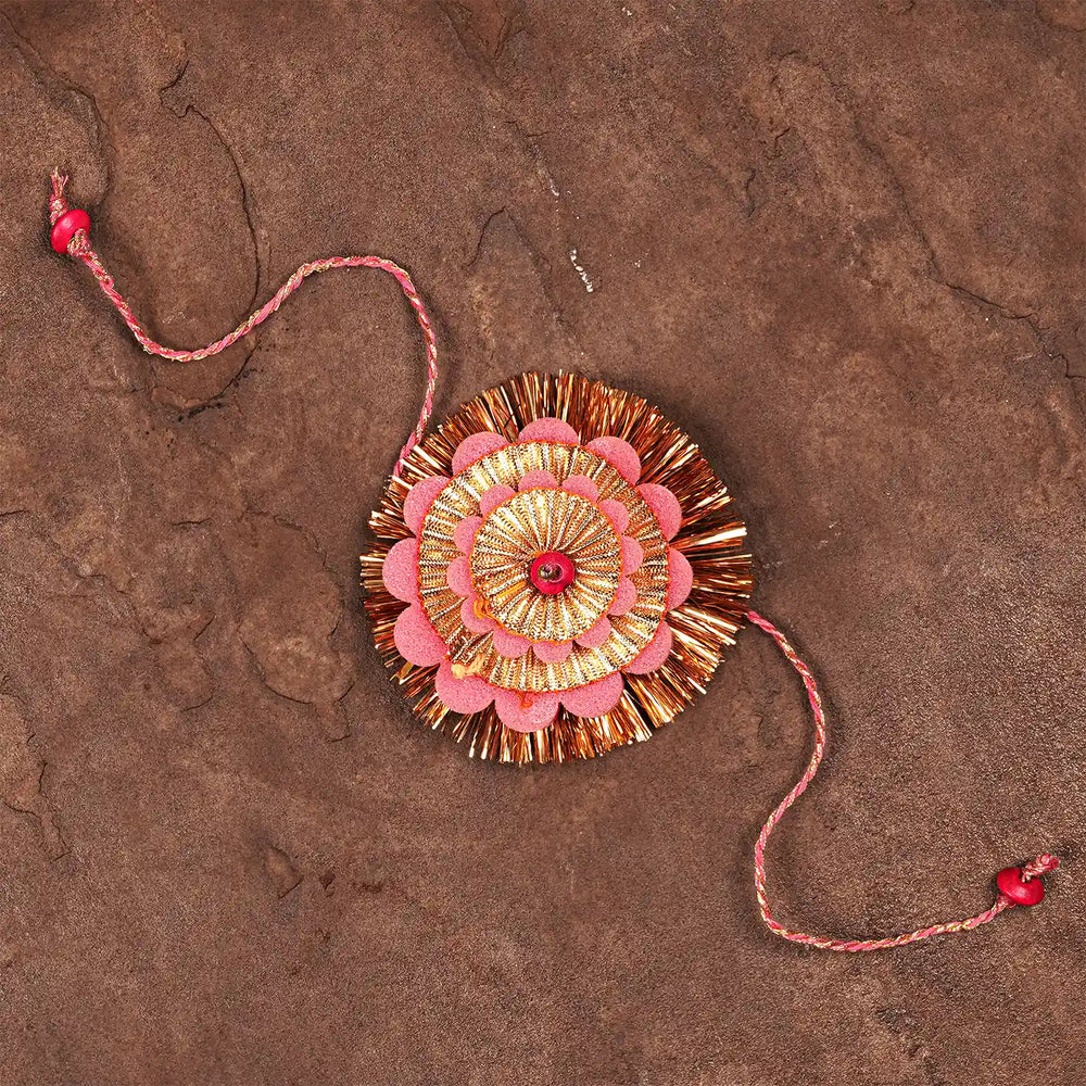 Handmade Layered Pink And Golden Foam Rakhi With Roli Chawal - Top Down View