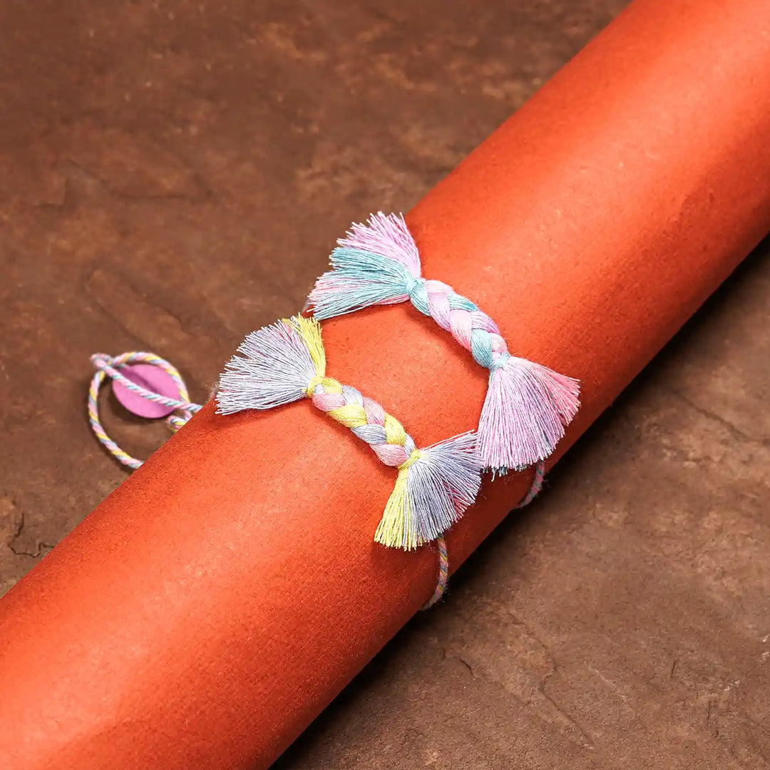 Handmade Braided Candy Rakhi With Roli Chawal Set Of 2 - Wrapped on Cylindrical Object