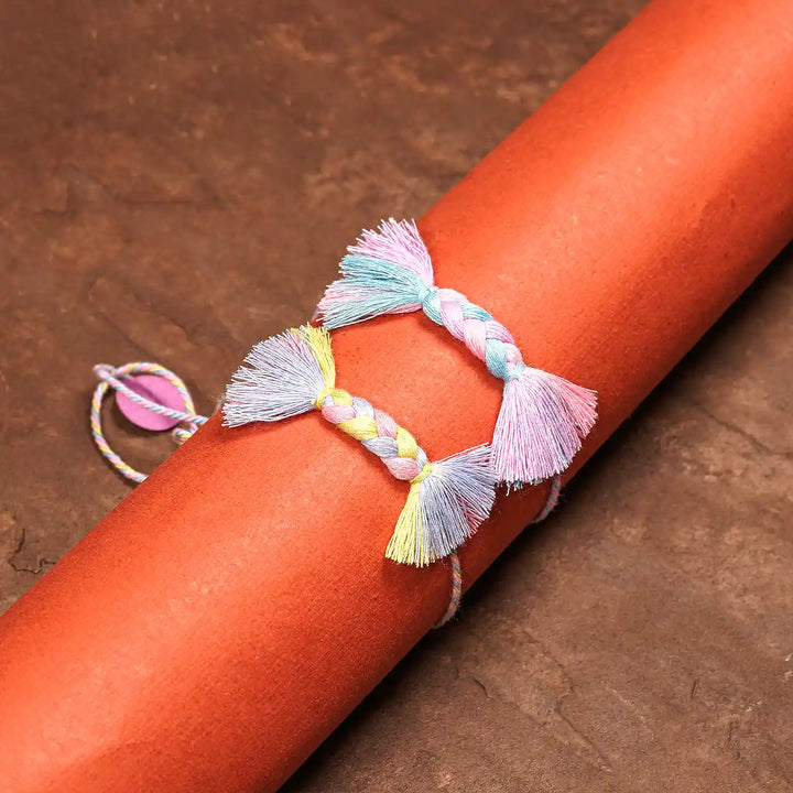 Handmade Braided Candy Rakhi With Roli Chawal Set Of 2 - Wrapped on Cylindrical Object