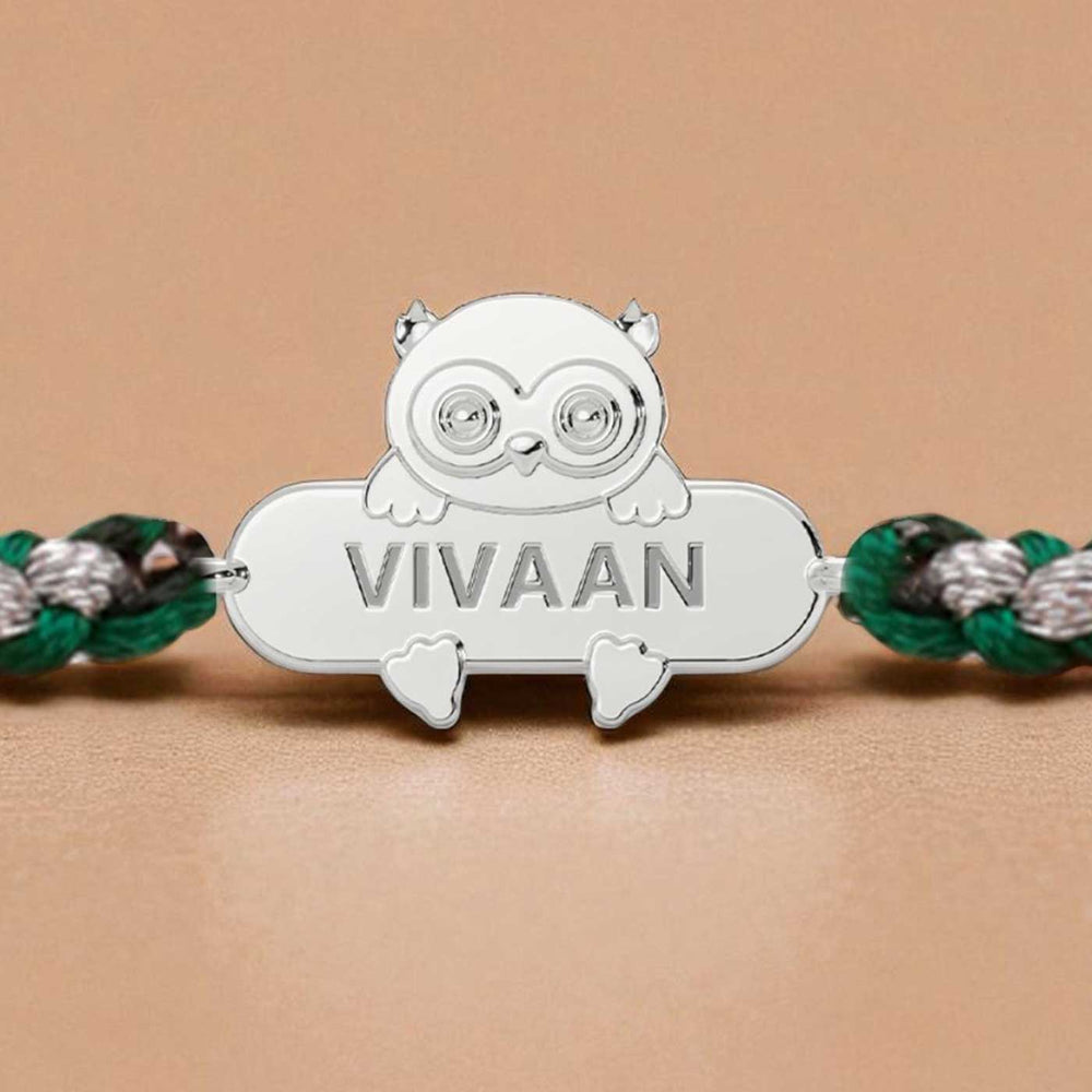 Personalized Handmade Owl Design Silver Kids Rakhi - Close-up of Name Engraving