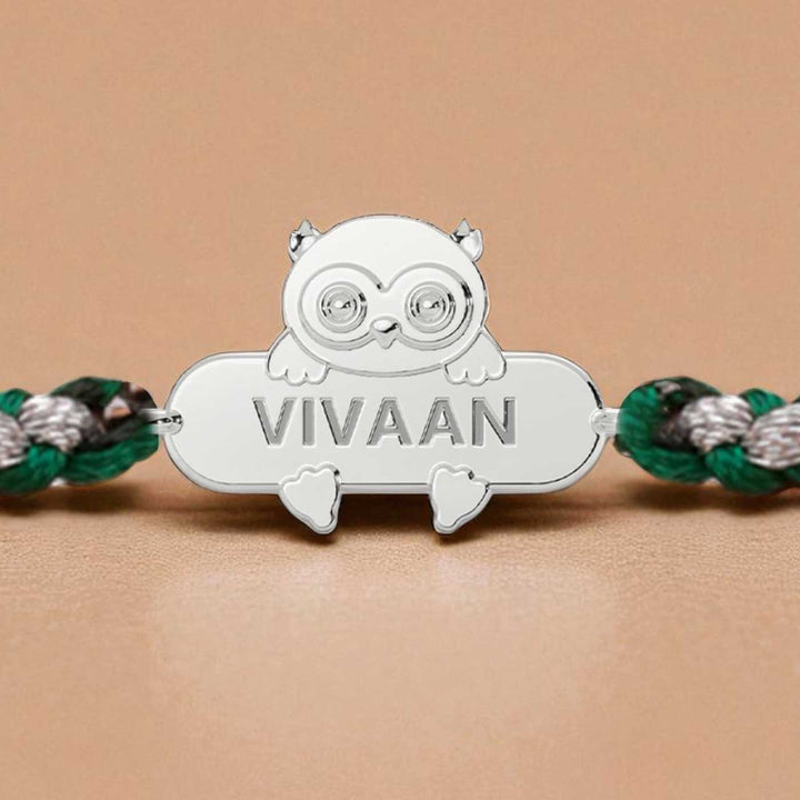 Personalized Handmade Owl Design Silver Kids Rakhi - Close-up of Name Engraving