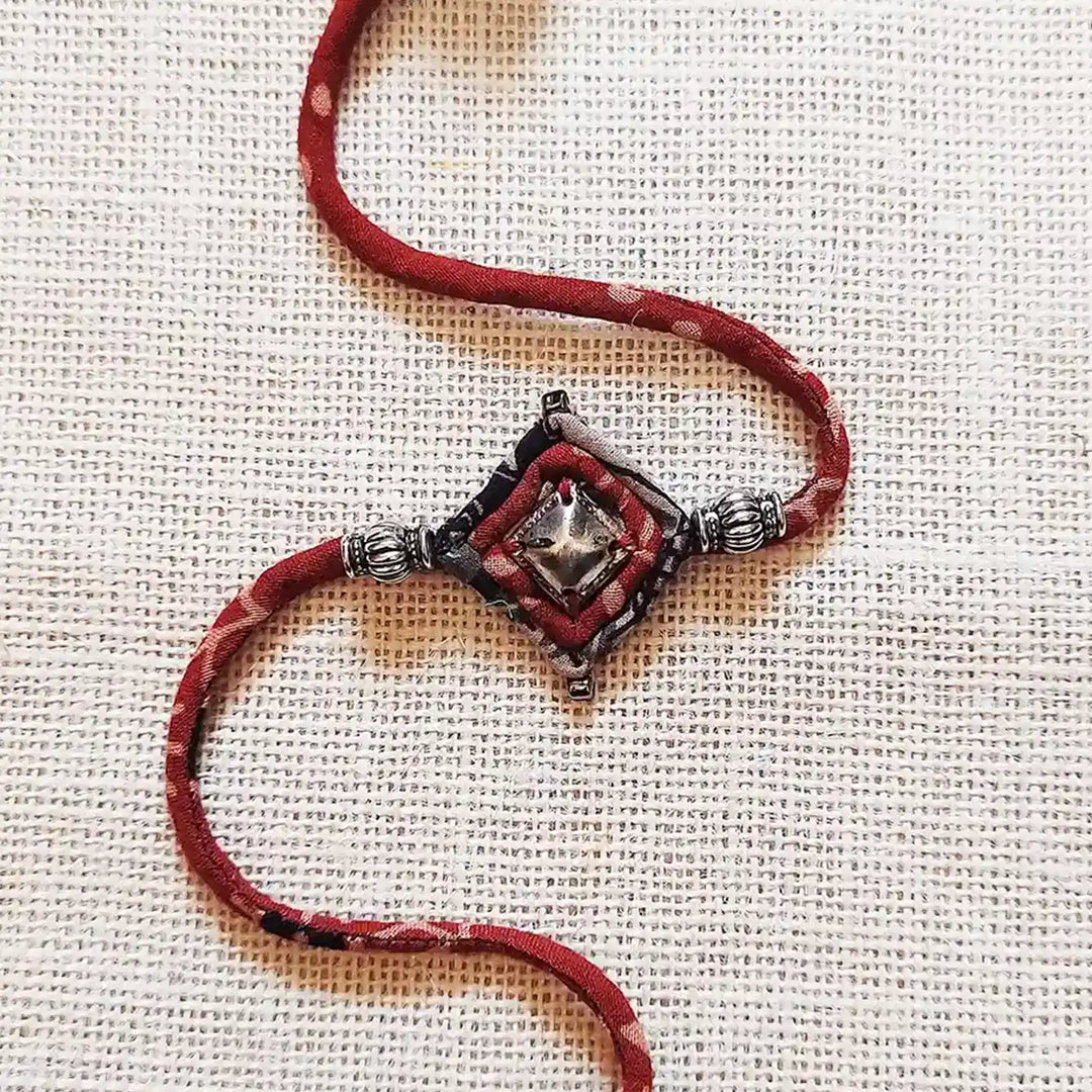 Handmade Dori Work Antique Metal Rakhi With Roli Chawal - Close-up of central design