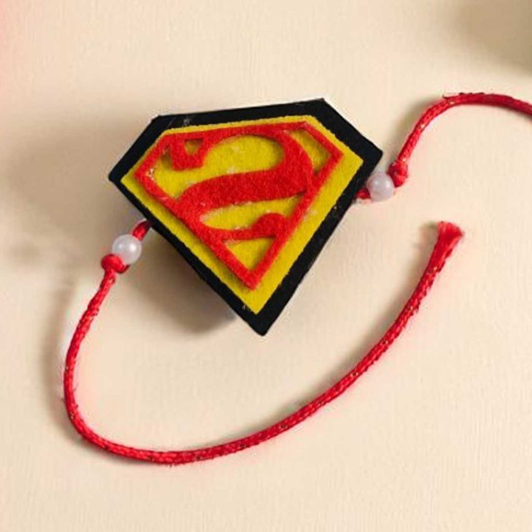 Handmade Beaded Superman Theme Pom Pom Felt Rakhi With Roli Chawal For Kids - Front View