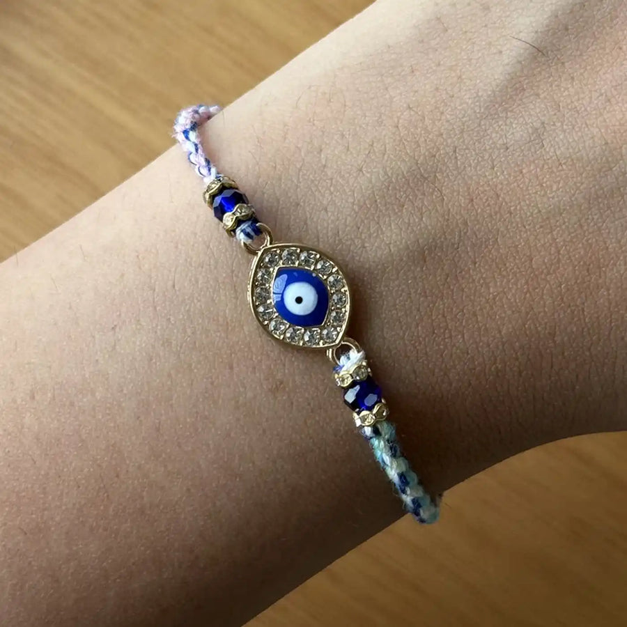 Handmade Stone Embedded Evil Eye Rakhi With Roli Chawal - Wrist Wearing Close-up