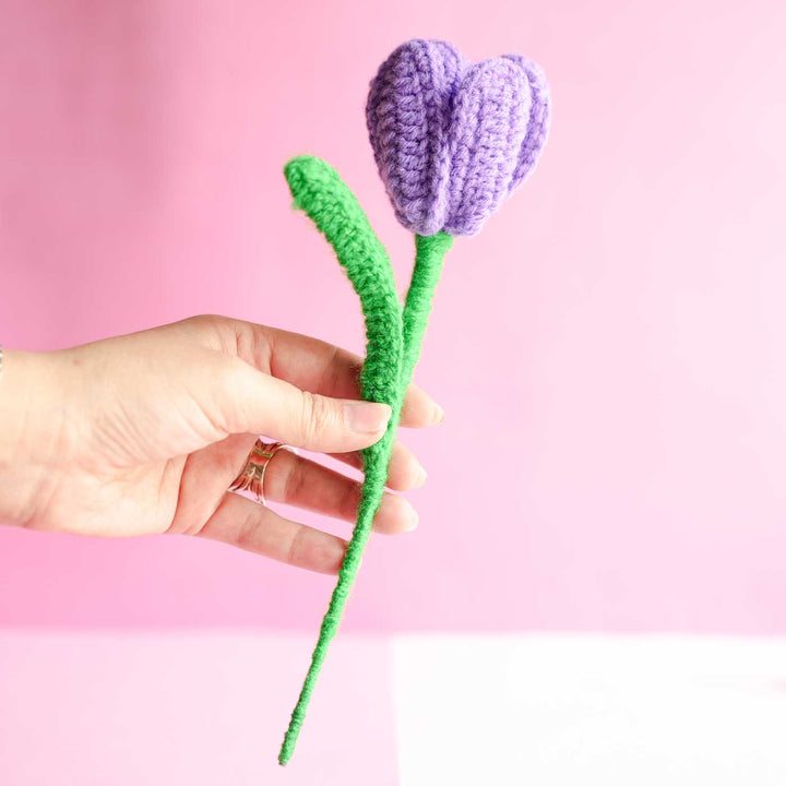 Personalized Handmade Crochet Tulip Dark Purple Rakhi Hamper Includes 1 Crochet Flower 1 Message Card And 2 Rakhis And Roli Chawal - Hand Displaying Full Product Length