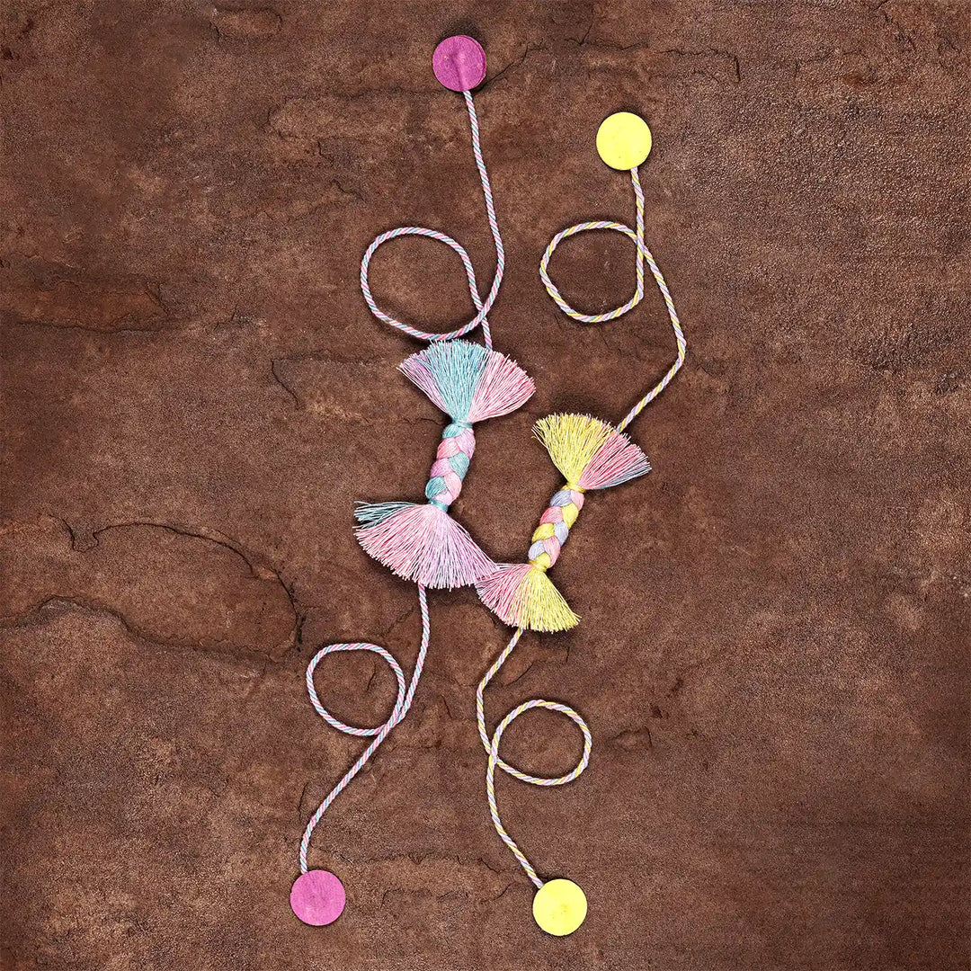 Handmade Braided Candy Rakhi With Roli Chawal Set Of 2 - Flat Lay with Colored Dots