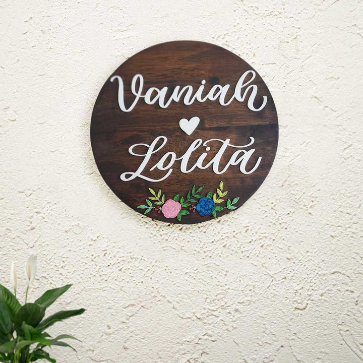 Personalized Round Floral Theme Wooden Name Plate - Mounted on textured wall background