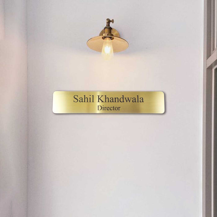 Personalized Weatherproof Sleek Gold Stainless Steel Name Plate - Mounted on Wall Below Light Fixture