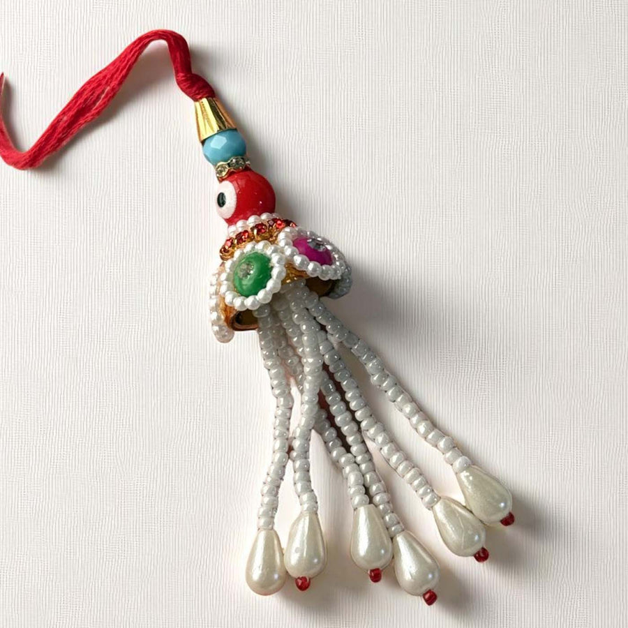 Handmade Red Evil Eye Lumba Rakhi For Bhabhi With Roli Chawal - Close-up Front View
